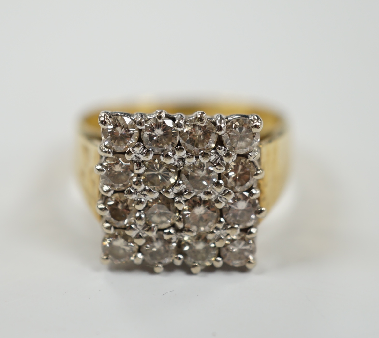 A modern textured 18ct gold and diamond cluster set tablet ring, size K/L, gross weight 6.8 grams.